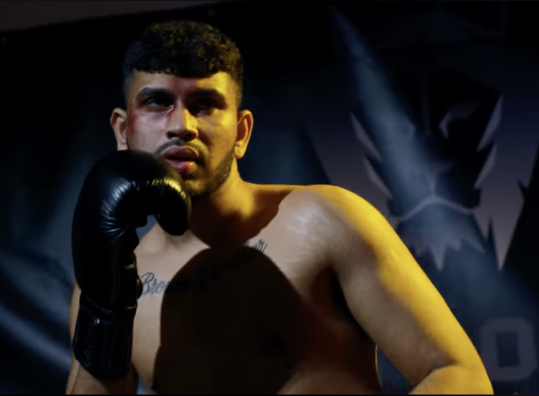 Sree as Benji in the ring, glove raised, one eye bruised