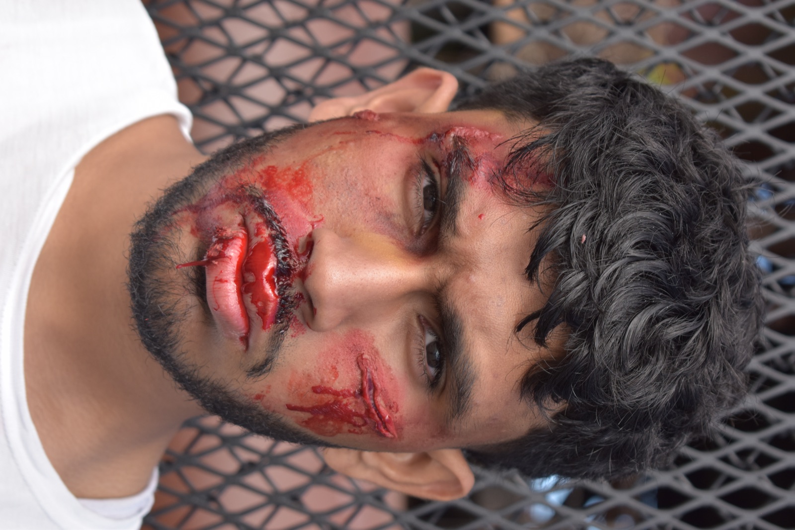Sree as Benji in bloodied fight makeup, staring into the camera